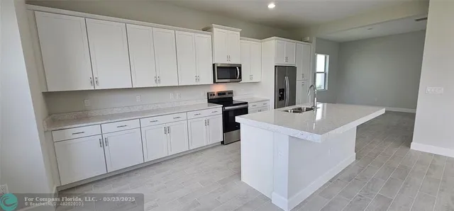 a kitchen with white cabinets and white appliances