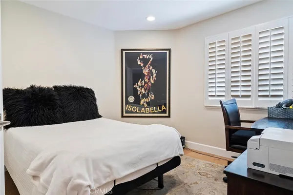 a bedroom with a bed and a desk