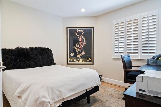 a bedroom with a bed and a desk