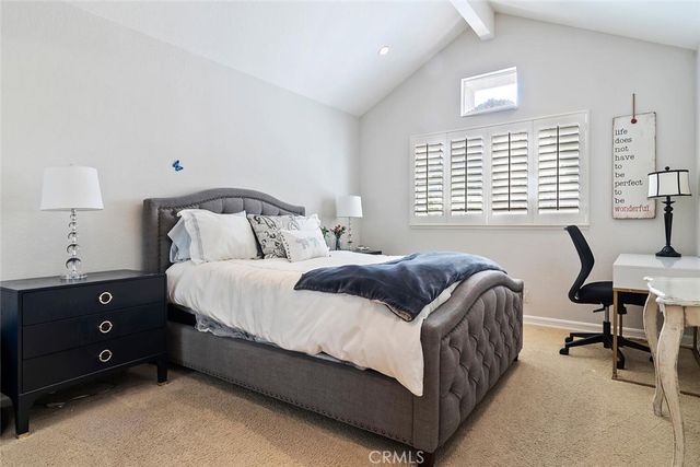 a bedroom with a bed a lamp and a window