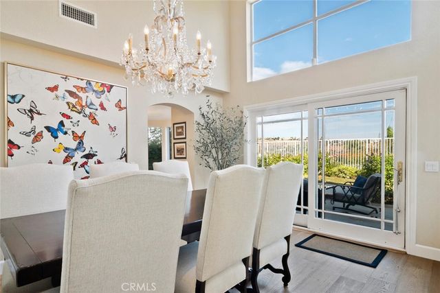 a view of a dining room with furniture and a chandelier