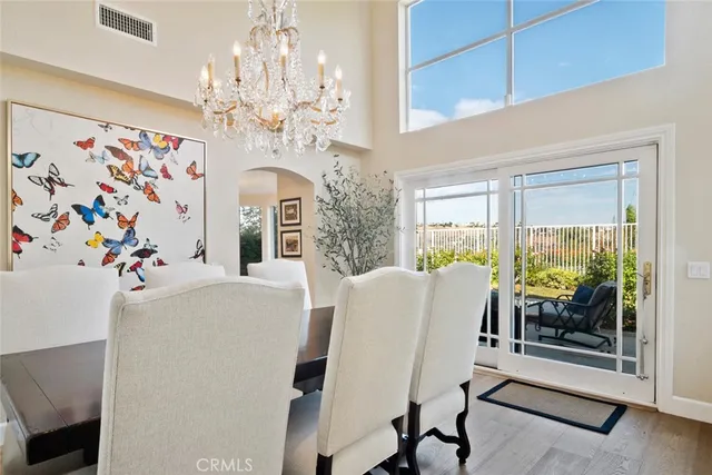 a view of a dining room with furniture and a chandelier
