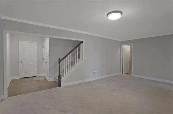 a view of an empty room with stairs
