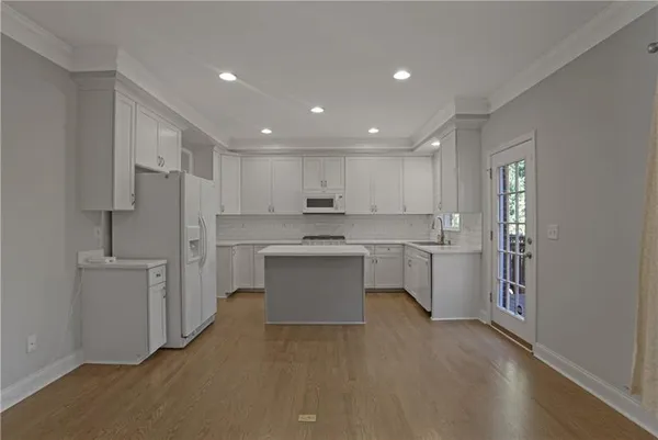 a kitchen with white cabinets and stainless steel appliances
