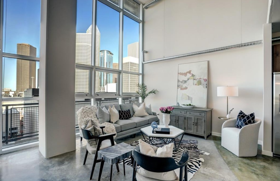 a living room with furniture and a large window