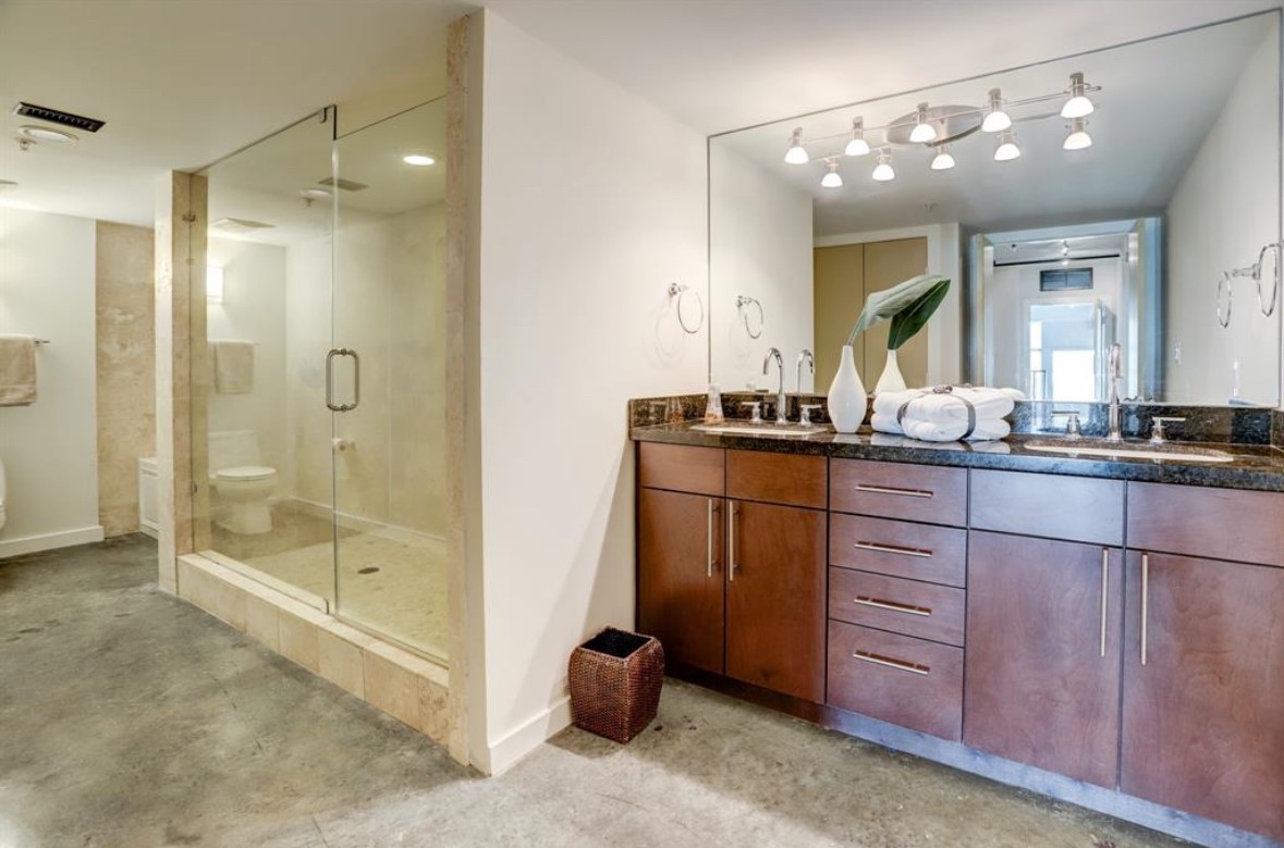 2000 Bagby Street, Unit 9420 Houston, TX 77002 - Photo 16 of 30 a bathroom with a shower sink and mirror
