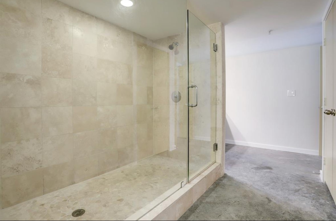 2000 Bagby Street, Unit 9420 Houston, TX 77002 - Photo 17 of 30 a bathroom with a shower and a glass door