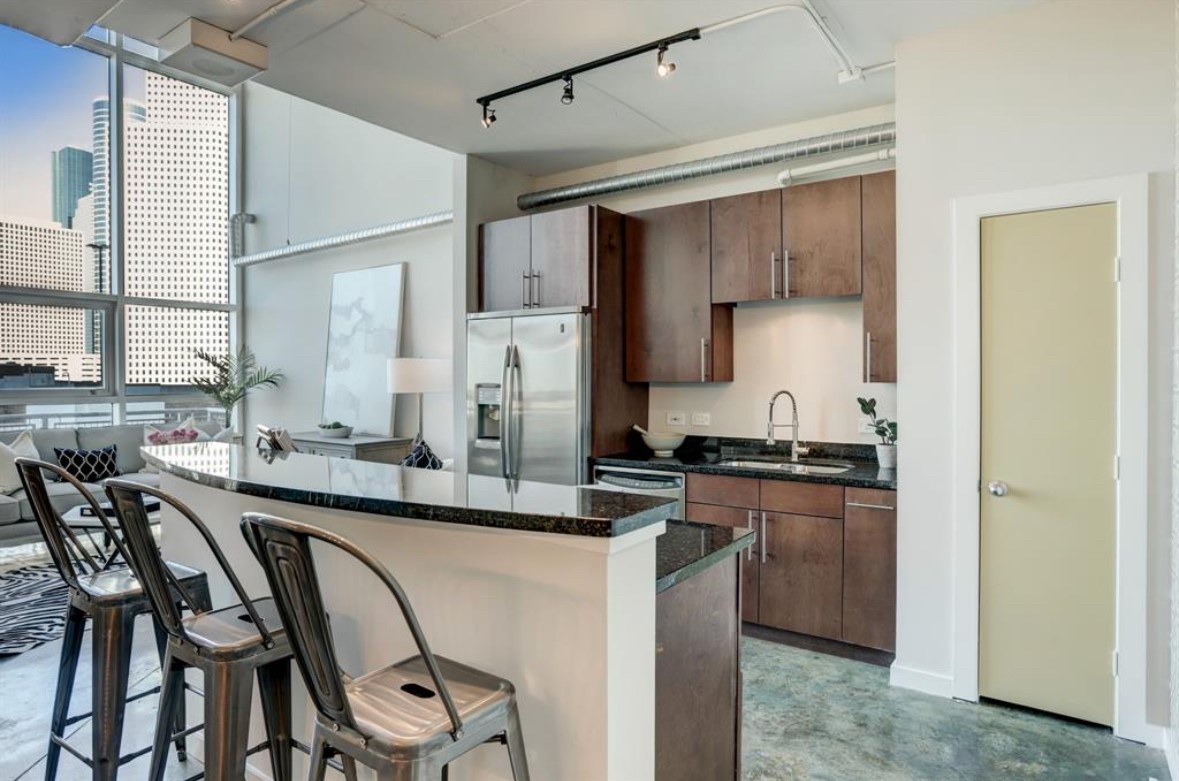 2000 Bagby Street, Unit 9420 Houston, TX 77002 - Photo 4 of 30 a kitchen with stainless steel appliances granite countertop a stove a sink dishwasher a refrigerator with a dining table and chairs