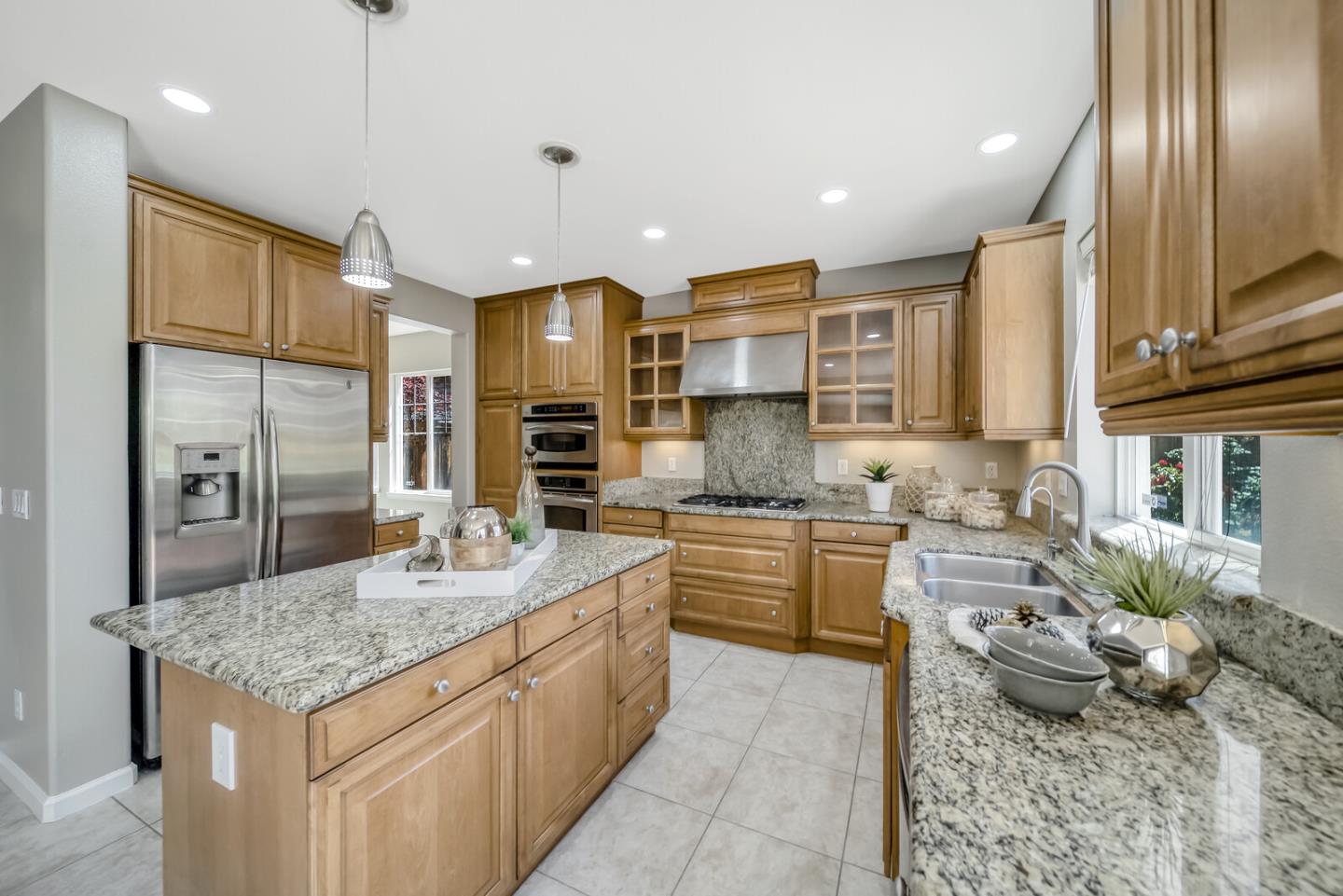 1226 Halifax Way San Ramon, CA 94582 - Photo 5 of 13 a large kitchen with kitchen island granite countertop a large counter top stainless steel appliances and cabinets