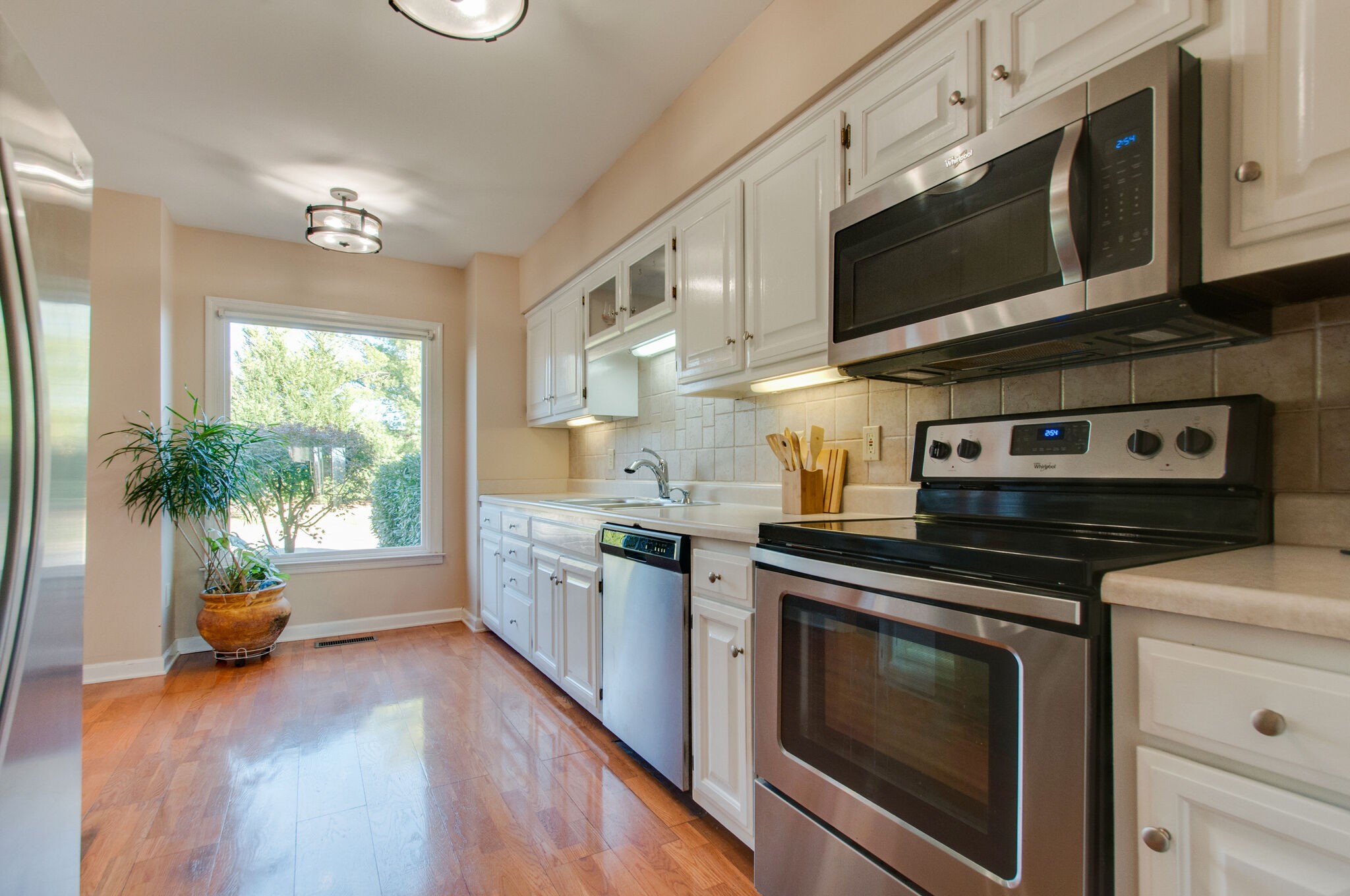 149 Morton Mill Circle Nashville, TN 37221 - Photo 14 of 27 a kitchen with stainless steel appliances a stove a microwave and cabinets