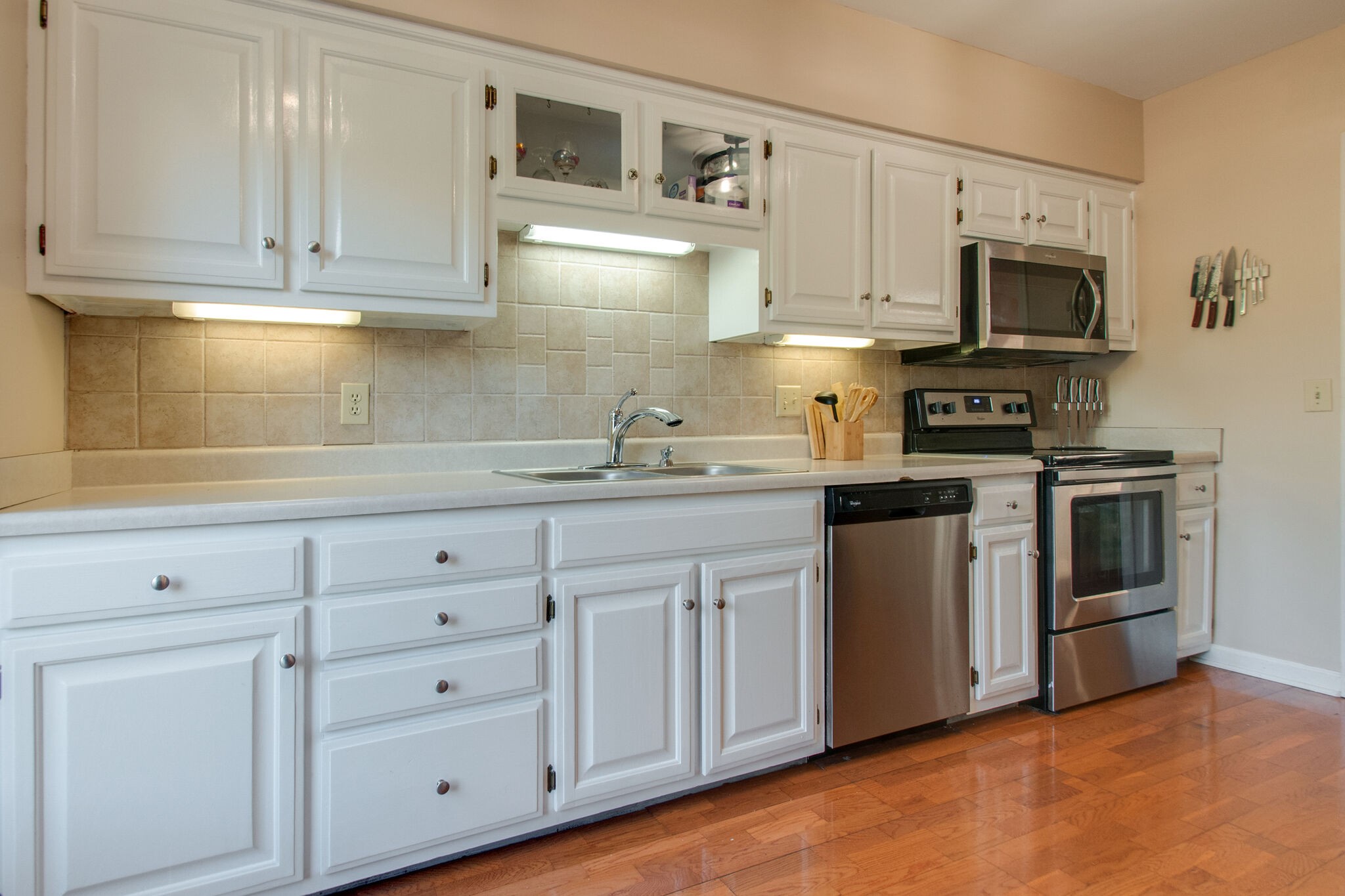 149 Morton Mill Circle Nashville, TN 37221 - Photo 16 of 27 a kitchen with white cabinets stainless steel appliances and sink