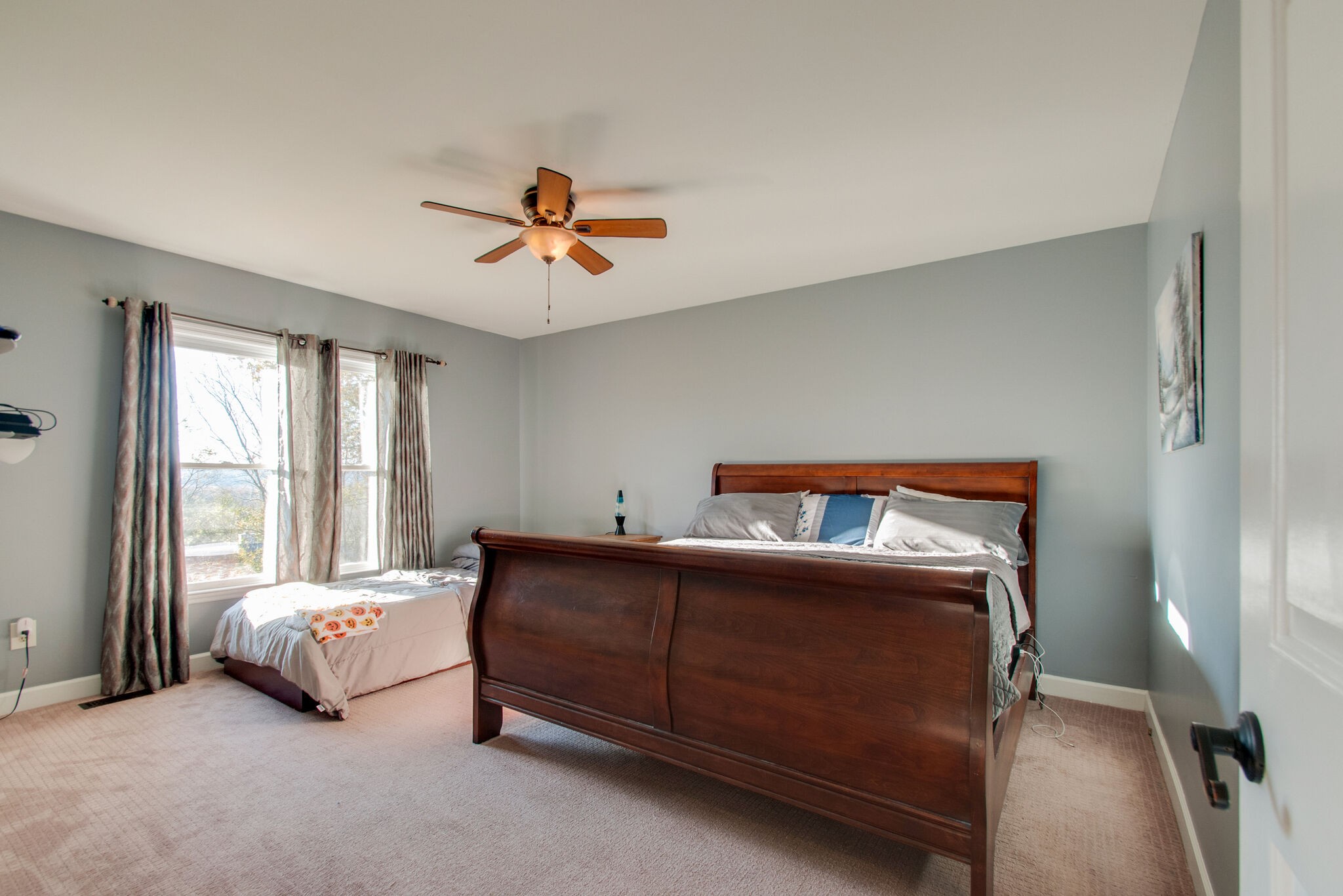 149 Morton Mill Circle Nashville, TN 37221 - Photo 18 of 27 a bedroom with a bed and a chandelier