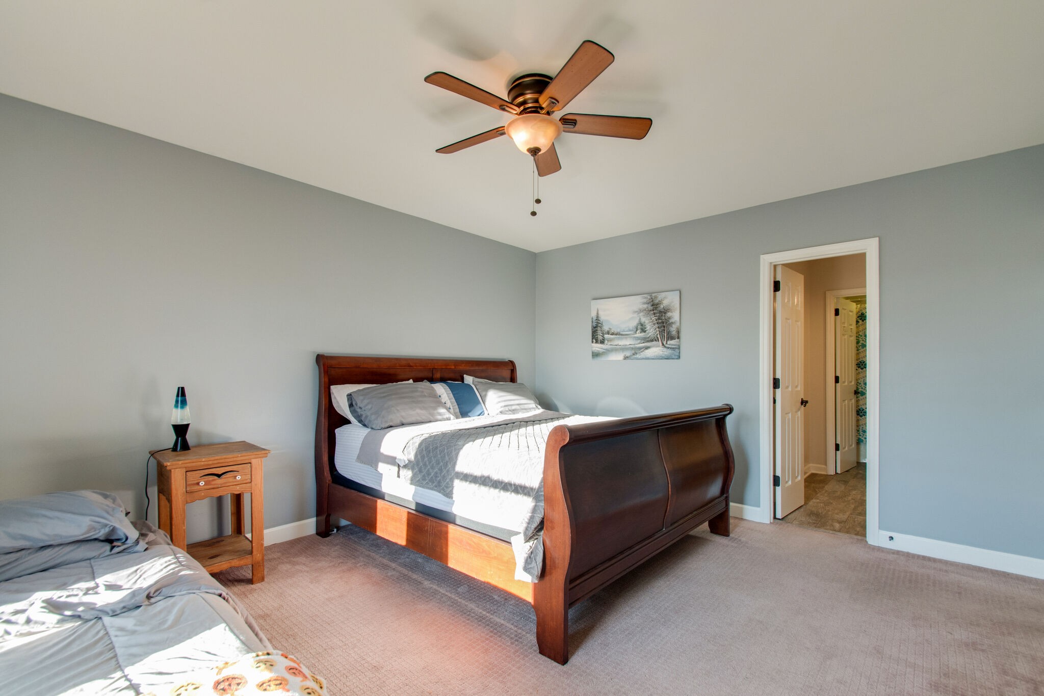 149 Morton Mill Circle Nashville, TN 37221 - Photo 19 of 27 a spacious bedroom with a bed and a ceiling fan