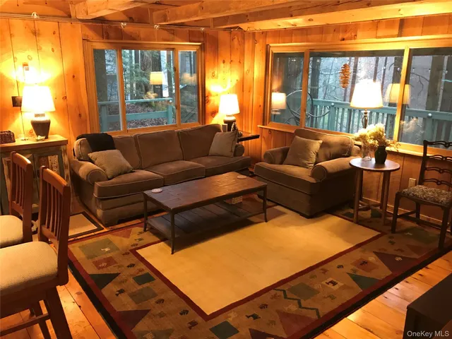 a living room with furniture and large windows