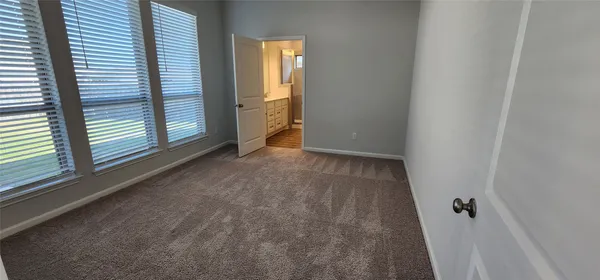 a view of hallway with wooden floor and stairs