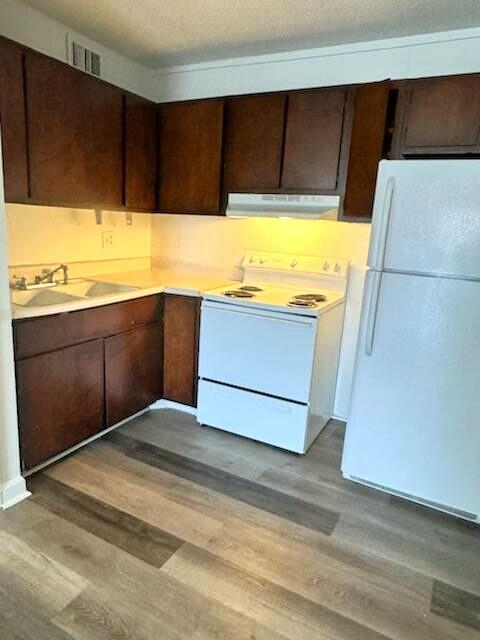 a view of kitchen with wooden floor