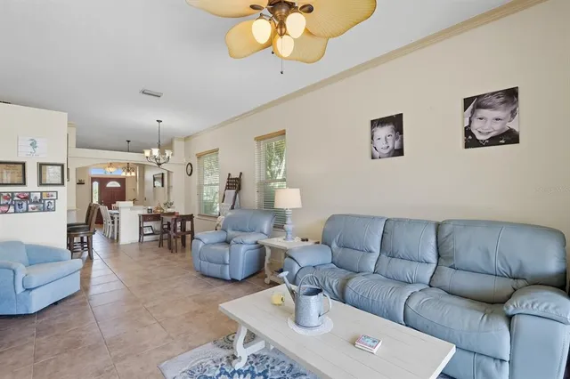 a living room with furniture a rug and a chandelier