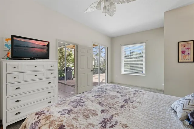 a bedroom with a bed and a flat screen tv in it