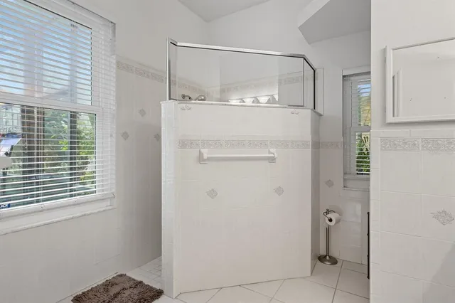 a bathroom with a glass shower door