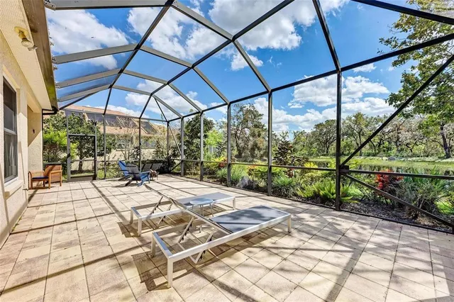 a view of a patio with a table chairs and a backyard