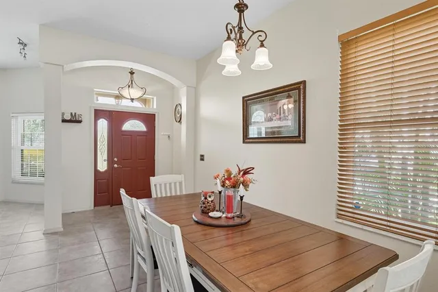 a view of a dining room with furniture and chandelier