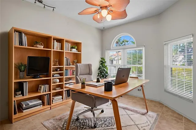 a work room with furniture and a flat screen tv