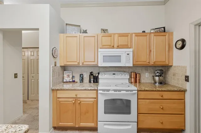 a kitchen with granite countertop cabinets stainless steel appliances and a sink
