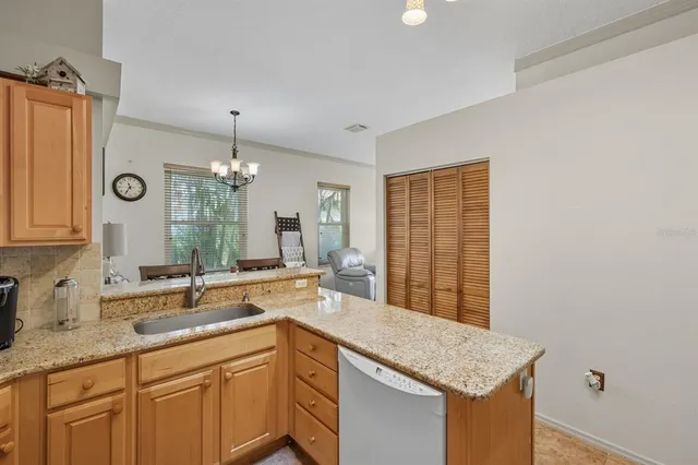 a kitchen with a sink and a granite counter top