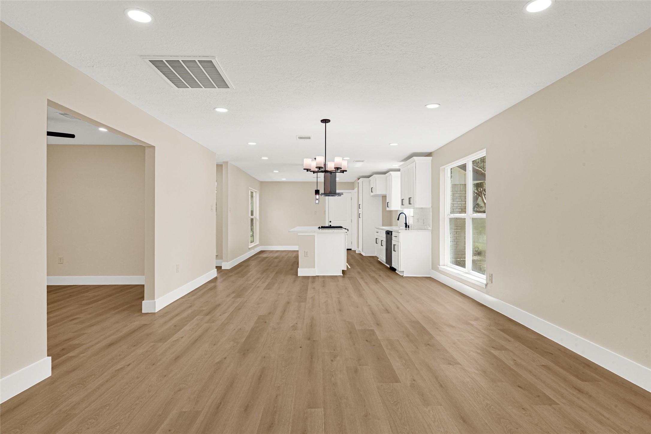3203 Falling Brook Drive Houston, TX 77345 - Photo 11 of 27 a view of a room with wooden floor ceiling fan and window