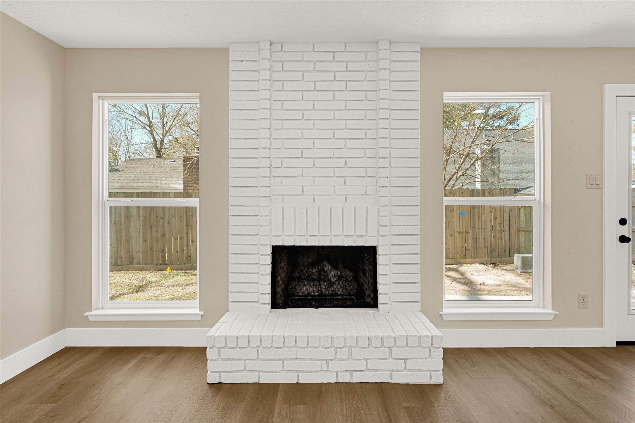 3203 Falling Brook Drive Houston, TX 77345 - Photo 15 of 27 a living room with a fireplace and a window