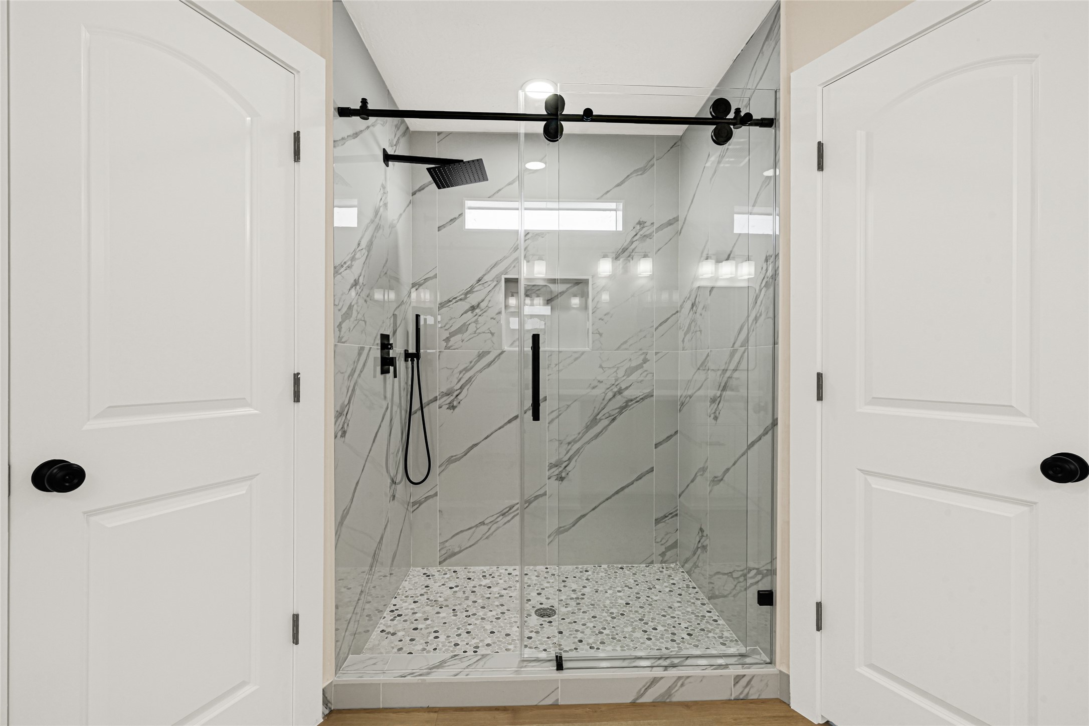 3203 Falling Brook Drive Houston, TX 77345 - Photo 19 of 27 a bathroom with a glass shower door