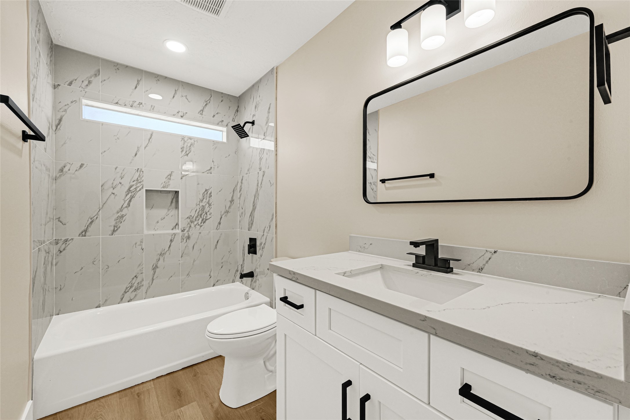 3203 Falling Brook Drive Houston, TX 77345 - Photo 21 of 27 a bathroom with a sink a toilet and a mirror