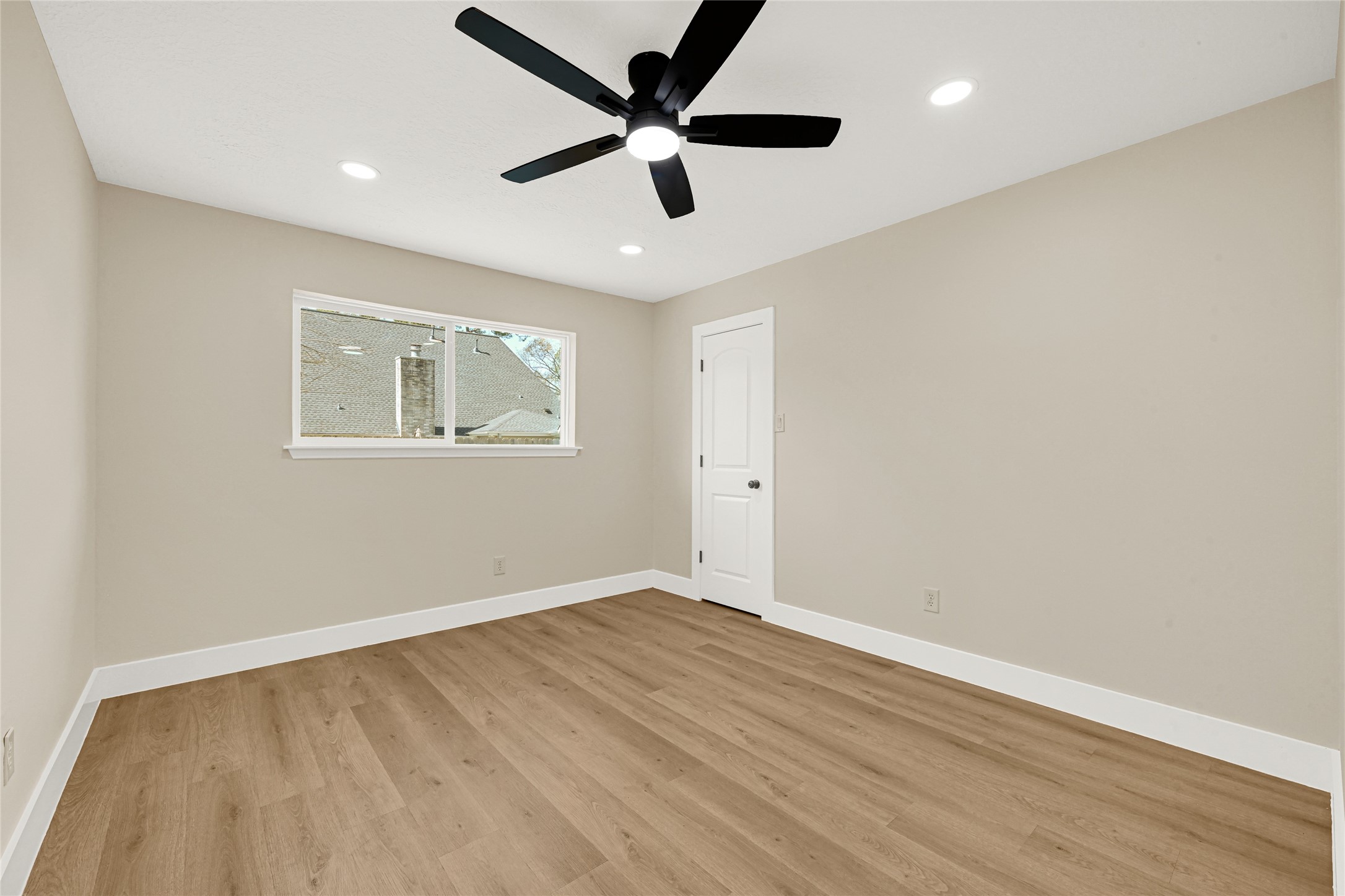 3203 Falling Brook Drive Houston, TX 77345 - Photo 22 of 27 wooden floor in an empty room with a window