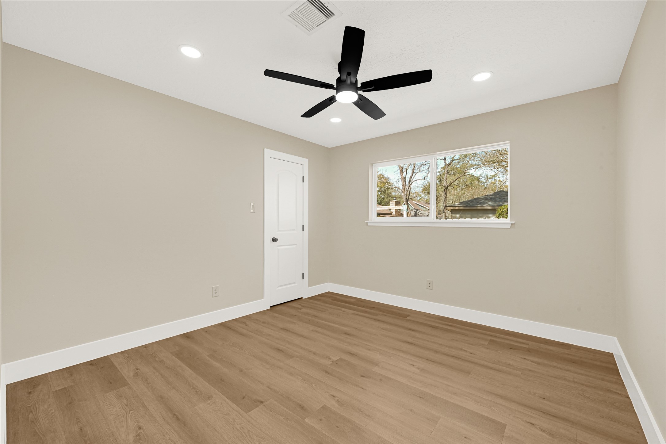 3203 Falling Brook Drive Houston, TX 77345 - Photo 23 of 27 a view of empty room with wooden floor and fan