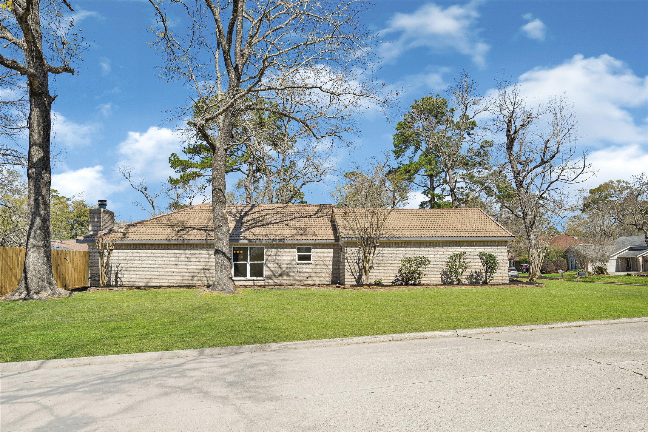 3203 Falling Brook Drive Houston, TX 77345 - Photo 25 of 27 a view of a house with a large tree