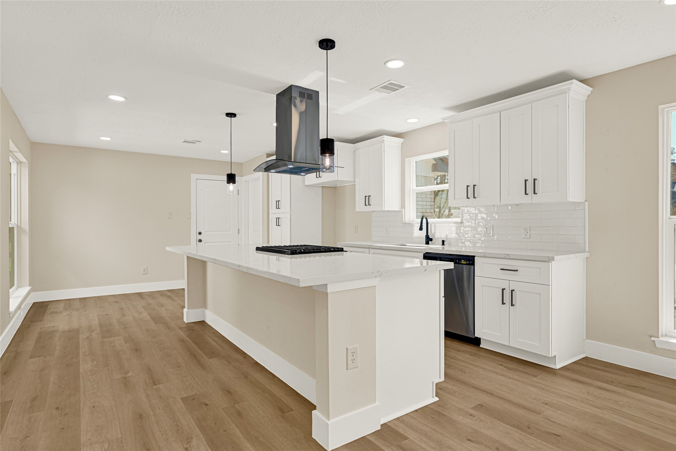 3203 Falling Brook Drive Houston, TX 77345 - Photo 5 of 27 a kitchen with a sink a stove cabinets and wooden floor
