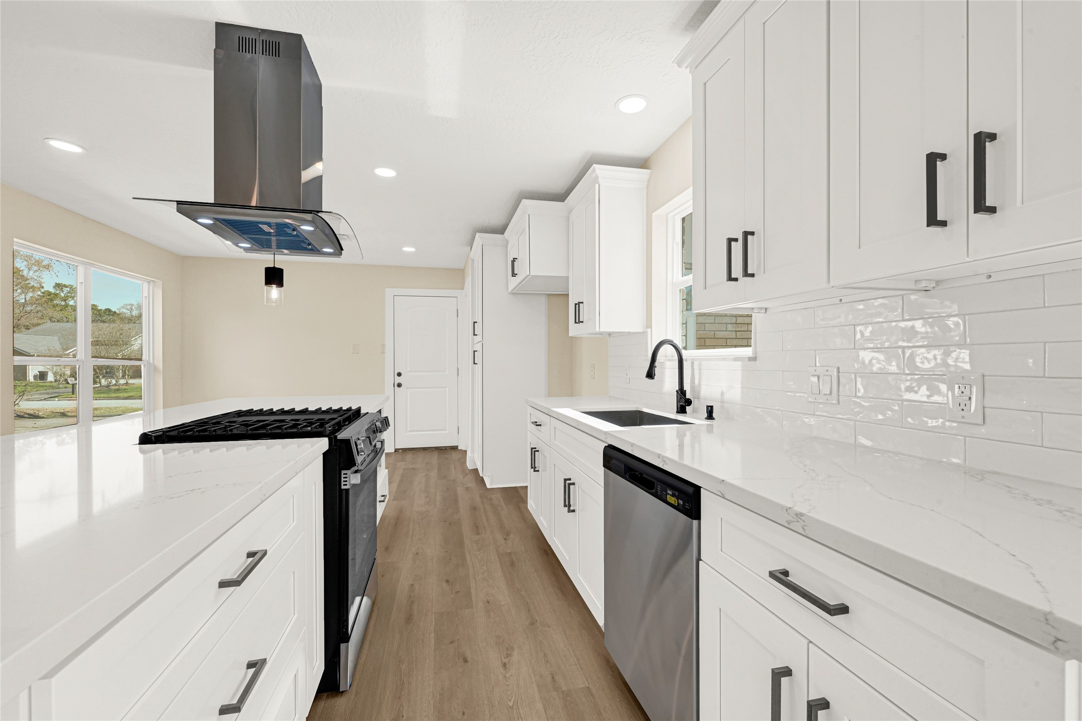 3203 Falling Brook Drive Houston, TX 77345 - Photo 6 of 27 a kitchen with stainless steel appliances a sink stove and cabinets