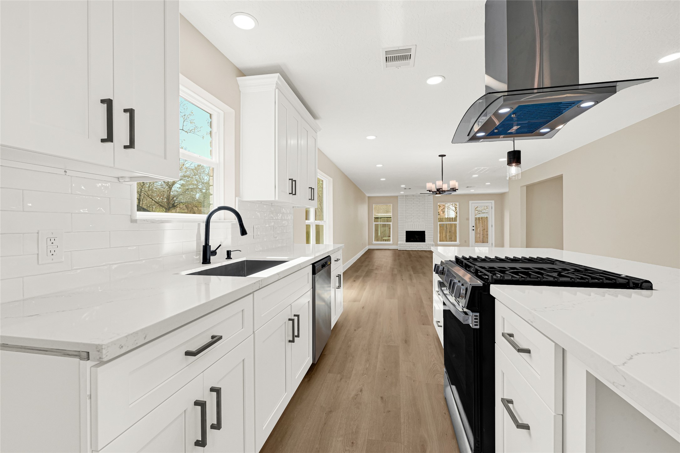 3203 Falling Brook Drive Houston, TX 77345 - Photo 7 of 27 a kitchen with a stove a sink and a refrigerator