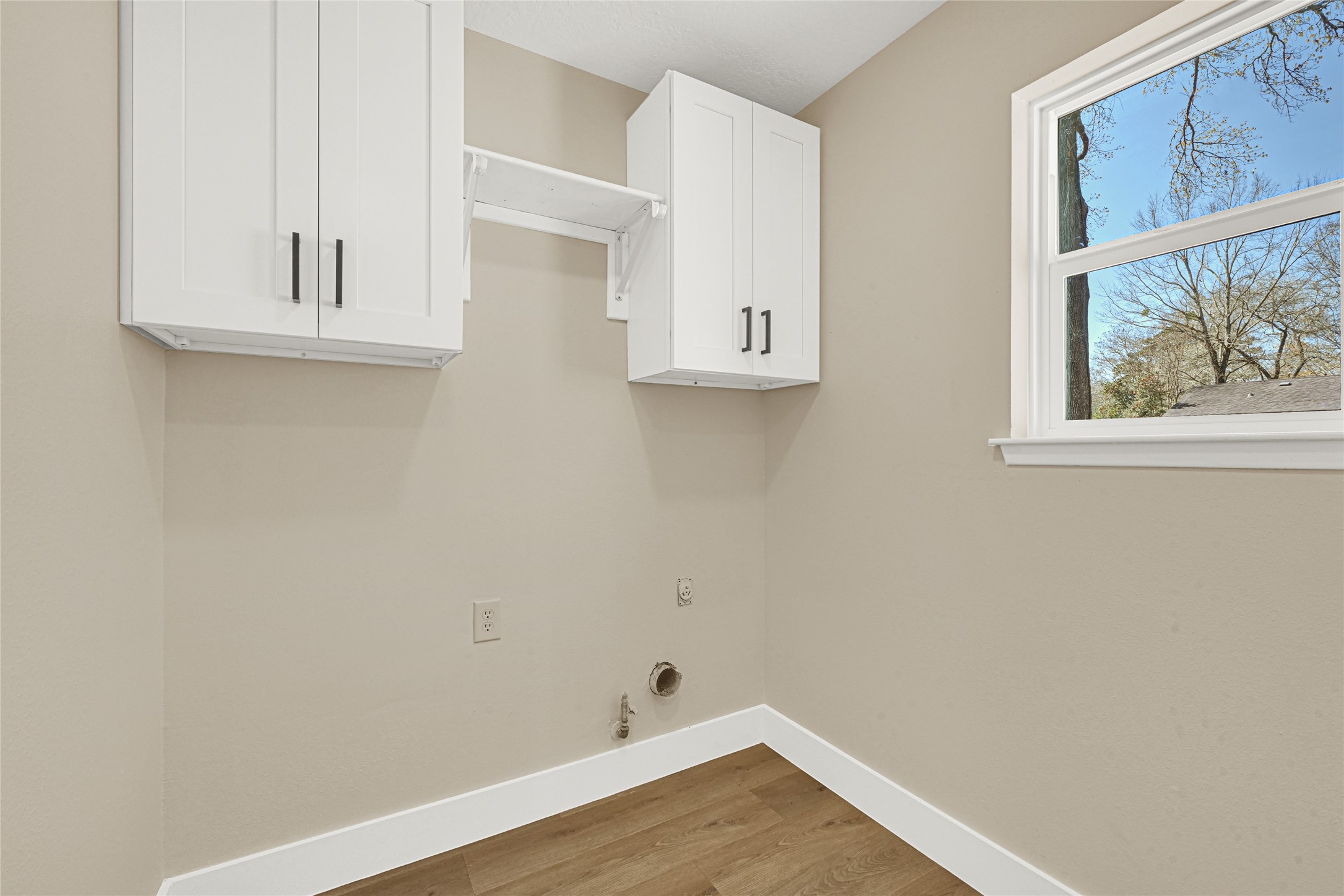 3203 Falling Brook Drive Houston, TX 77345 - Photo 9 of 27 a view of small space with wooden floor and a window