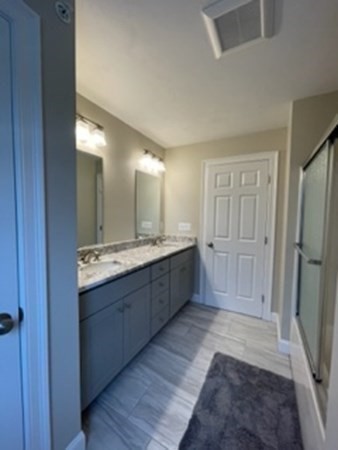 21 Gibbs Road Berlin, MA 01503 - Photo 18 of 29 a large bathroom with a double vanity sink and a mirror
