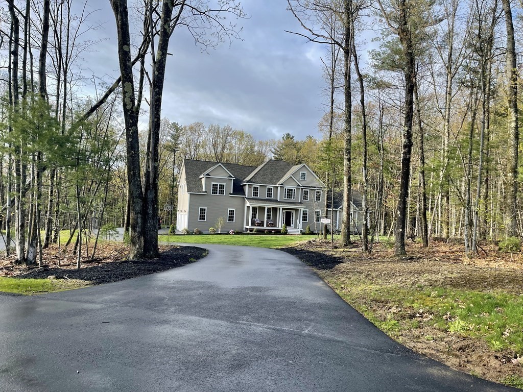 21 Gibbs Road Berlin, MA 01503 - Photo 2 of 29 a front view of a house with a yard and garage