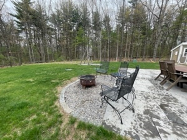 21 Gibbs Road Berlin, MA 01503 - Photo 24 of 29 a view of a backyard with chairs potted plants and a large tree