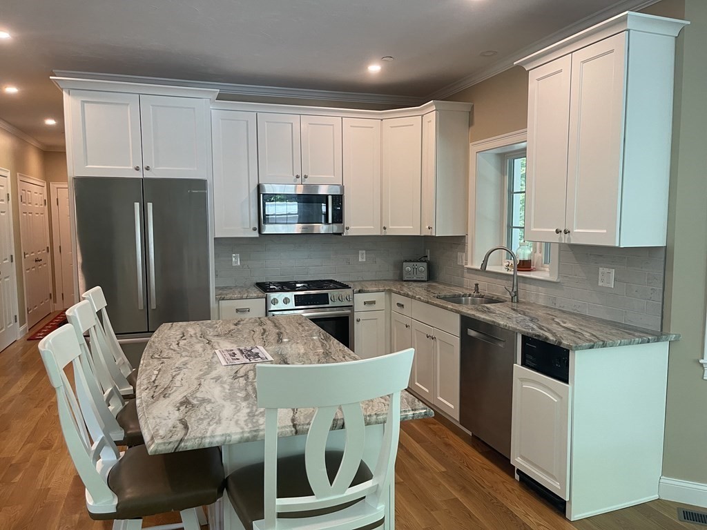 21 Gibbs Road Berlin, MA 01503 - Photo 8 of 29 a kitchen with stainless steel appliances granite countertop a white cabinets and a refrigerator