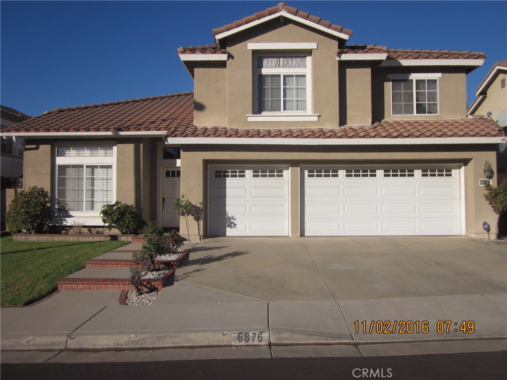 6876 Rovato Place Rancho Cucamonga, CA 91701 - Photo 1 of 1 a front view of a house with a yard