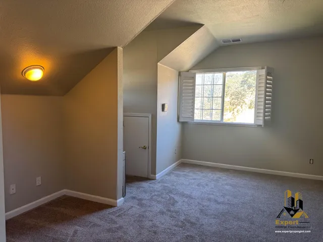an empty room with windows and closet
