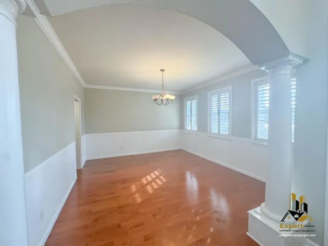 a large kitchen with kitchen island a large counter top space a sink stainless steel appliances and cabinets