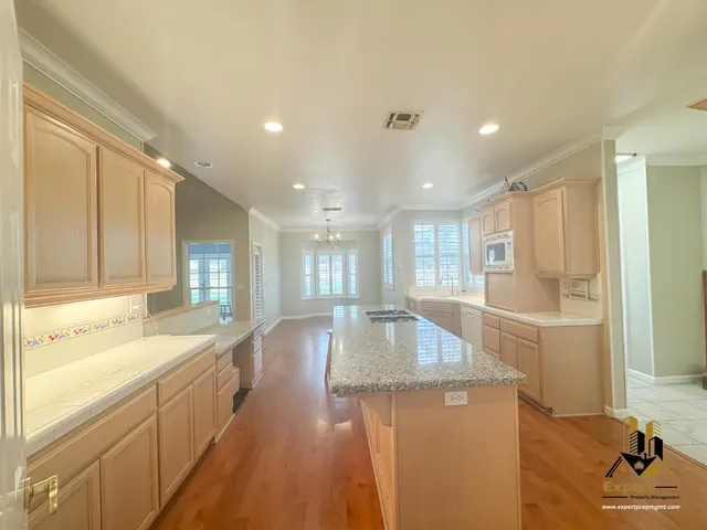 a view of a kitchen with wooden floor and a sink