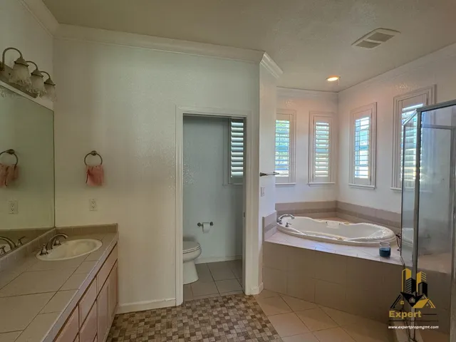 a bathroom with a tub sink and mirror