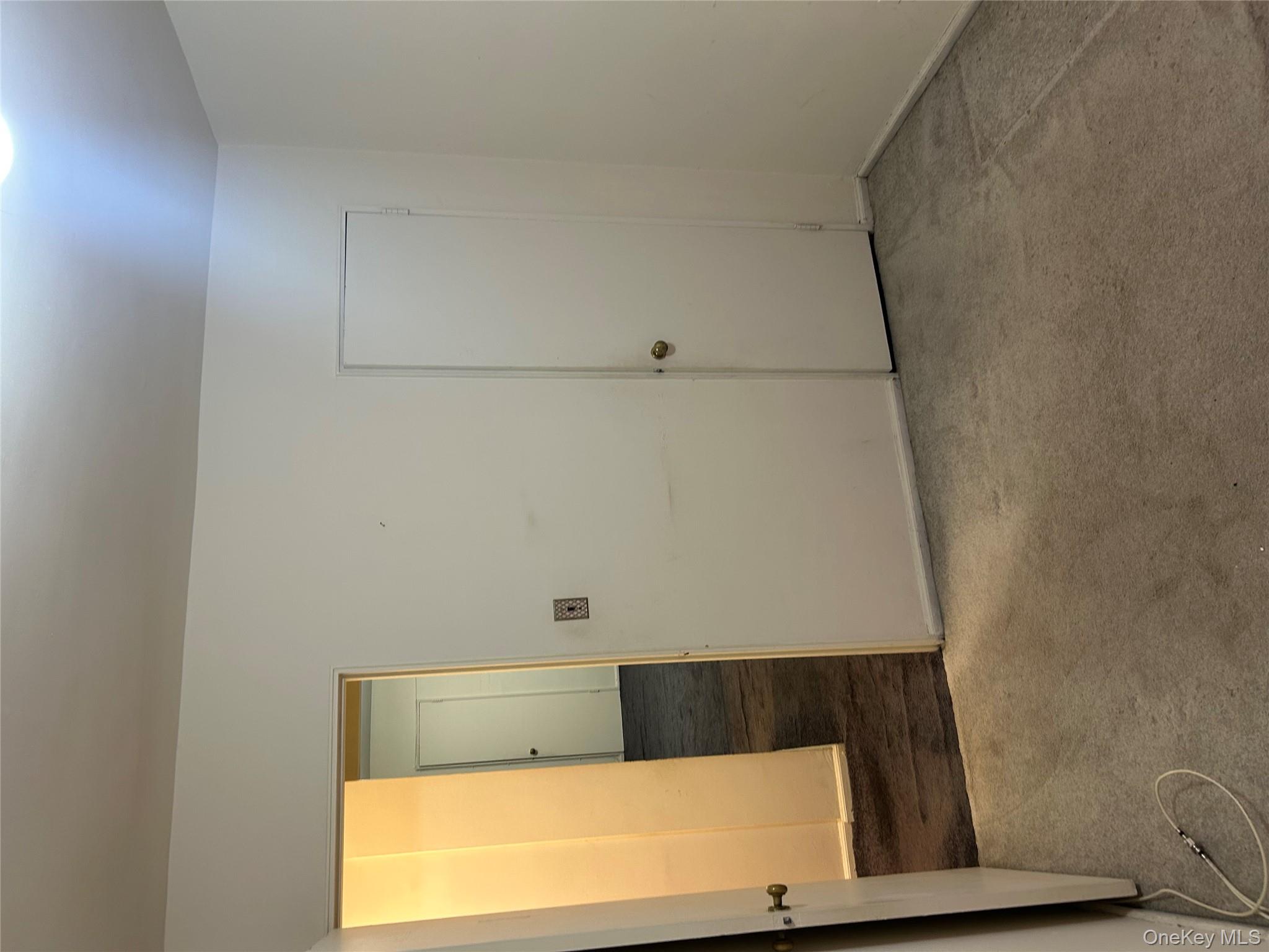 83-25 98th Street, Unit 2C Queens, NY 11421 - Photo 11 of 18 an empty room with wooden floor and windows