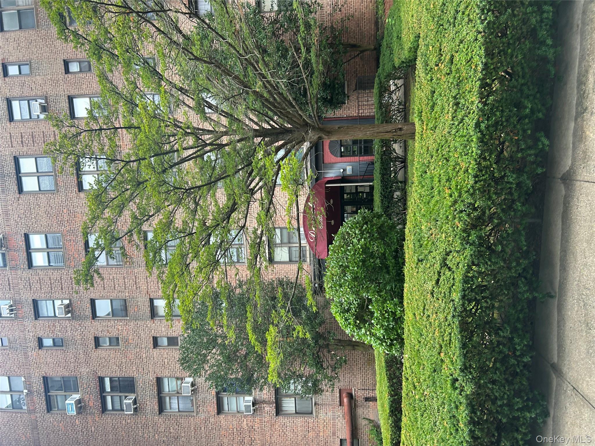 83-25 98th Street, Unit 2C Queens, NY 11421 - Photo 2 of 18 a front view of a building with a yard